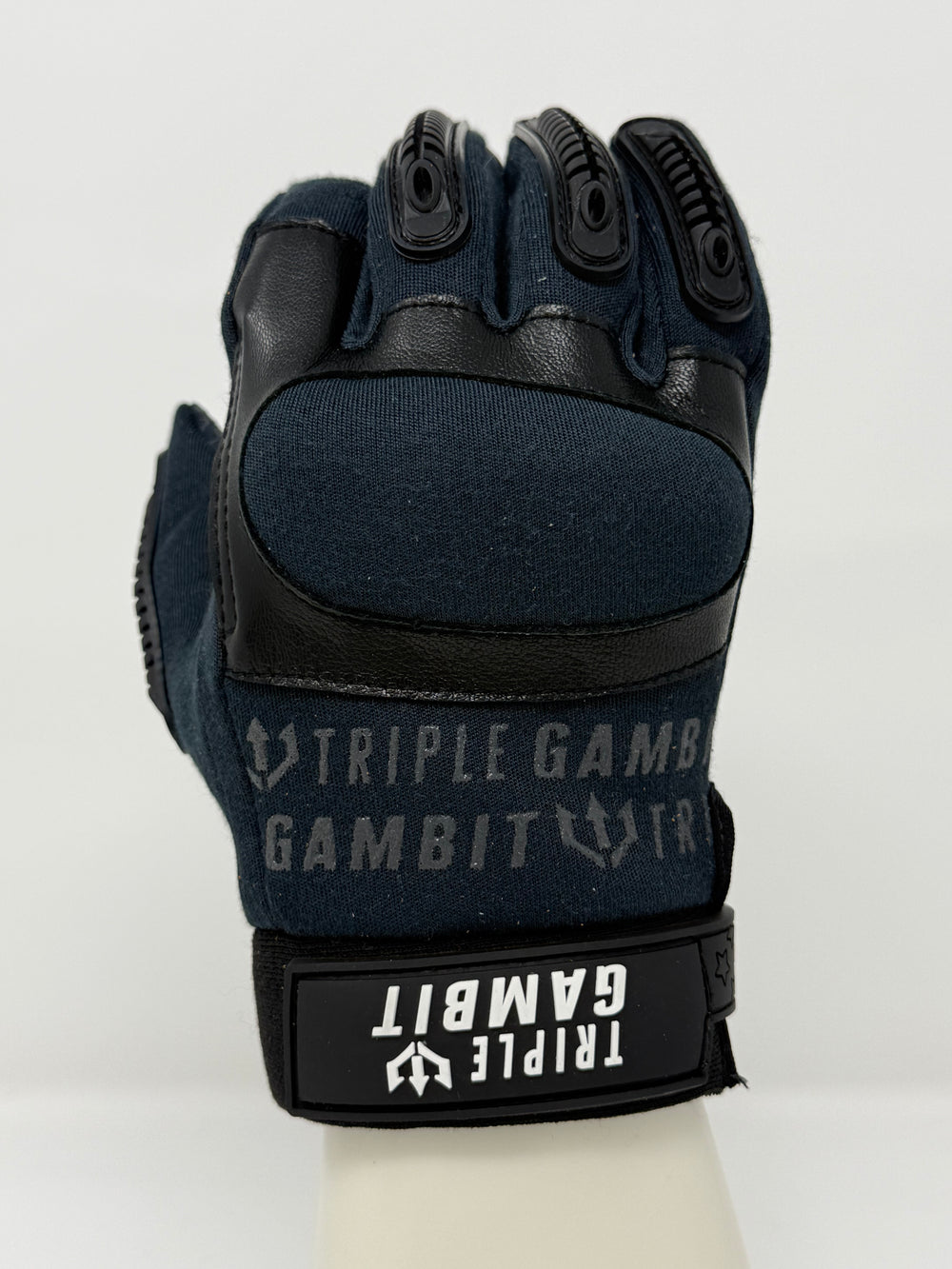 Black tactical glove with 'Triple Gambit' branding on a white background